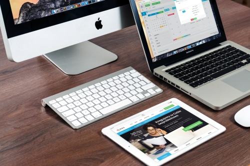 Website layouts displayed across desktop, laptop and tablet screens